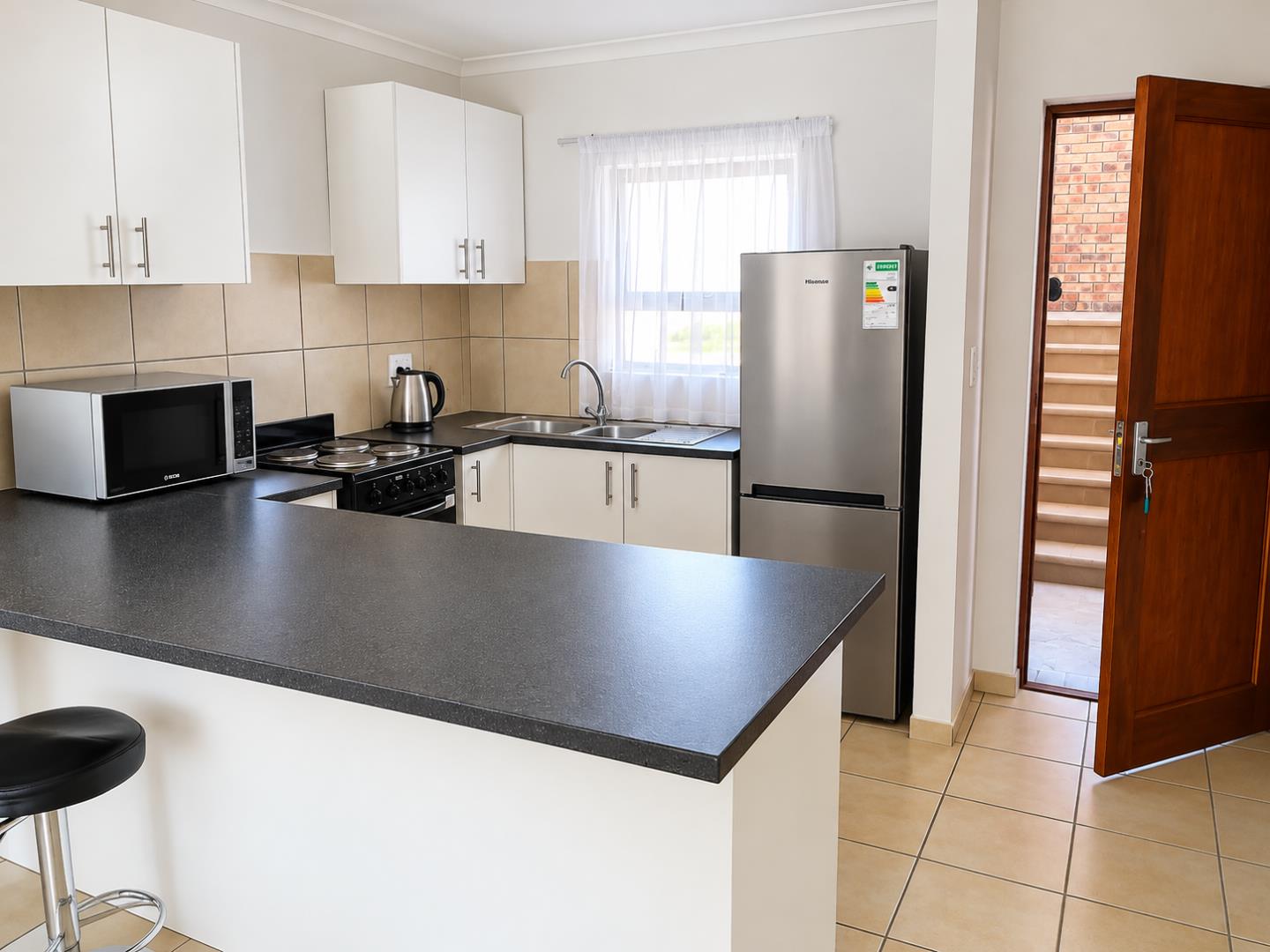 769280_Modern_Kitchen_with_Breakfast_Bar_and_Courtyard_Door.png