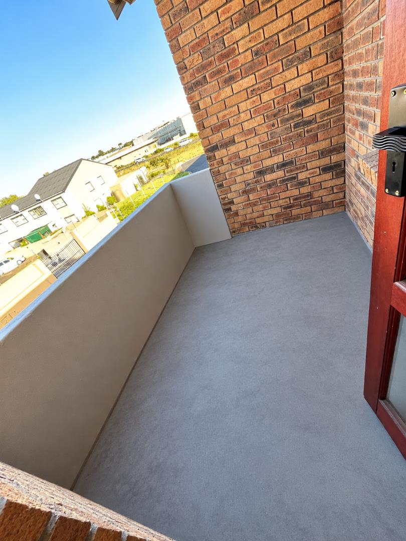 769655_Bright_Empty_Balcony_Overlooking_Suburbs.png