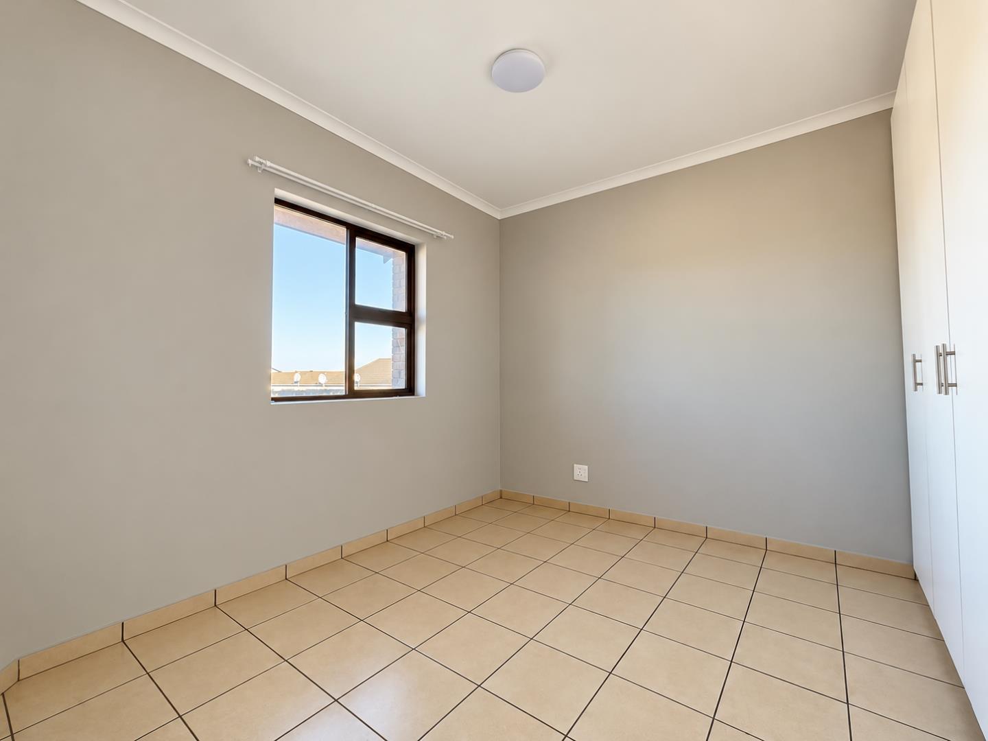 769655_Empty_Modern_Bedroom_with_Window_and_Wardrobe.png