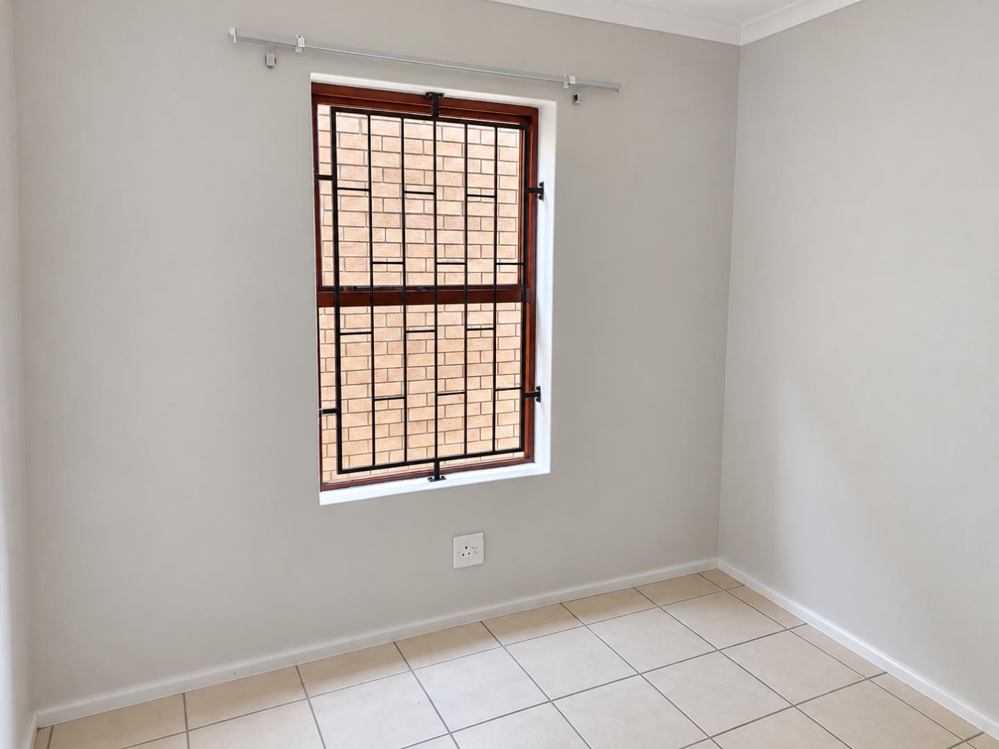 769798_Bright_Empty_Room_with_Barred_Window.png