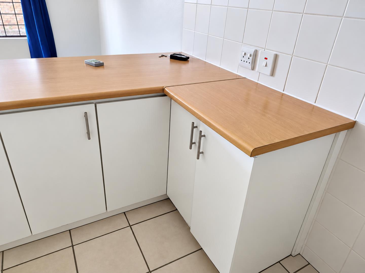 769798_Clean_White_Kitchen_Corner_with_Oak_Countertop.png